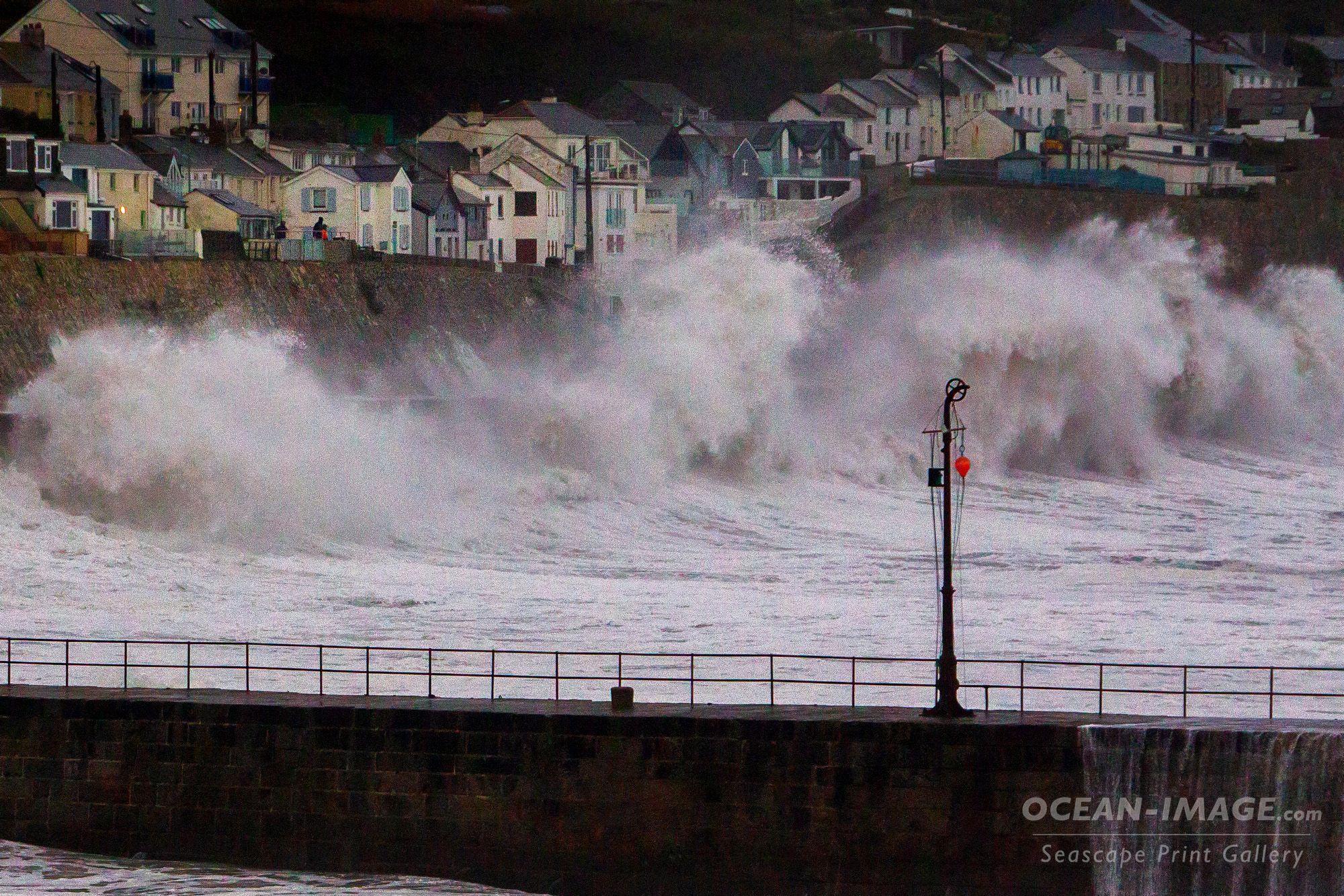 Wild waves hit a sea wall defence and spray upwards