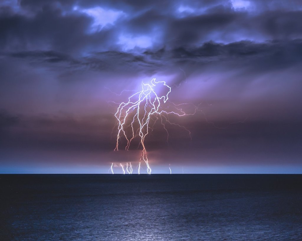 A_column_of_lightning_strikes_collected_with_a_3_min_exposure_at_Orange_Beach_by_Bradley_Huchteman_brxdlxy_1024x1024