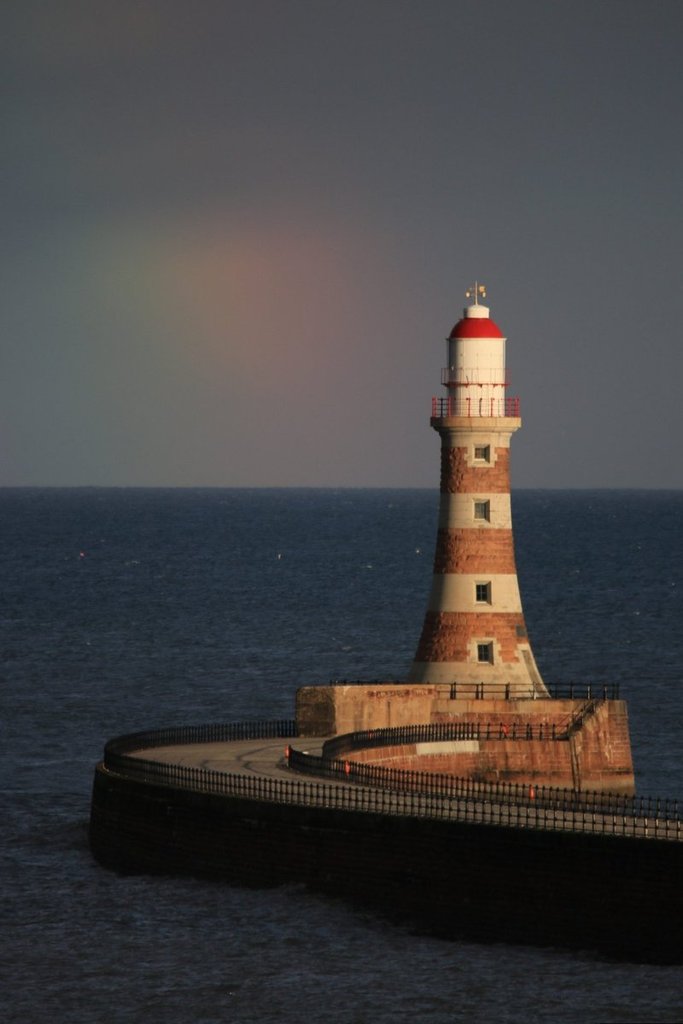 A_fading_rainbow_on_the_horizon_behind_Roker_Lighthouse_by_simon_c_woodley_simoncwoodley_1024x1024