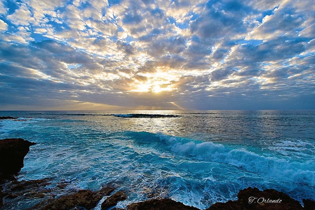 Sunset, Oahu, Hawaii from Kea'u Park. Beautiful rocky shore and vista.