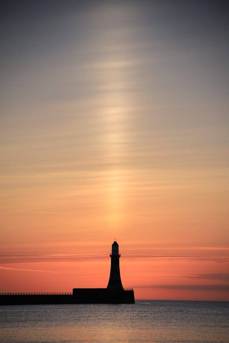 A beautiful ice crystal sun pillar at Roker Lighthouse by simon c woodley @simoncwoodley