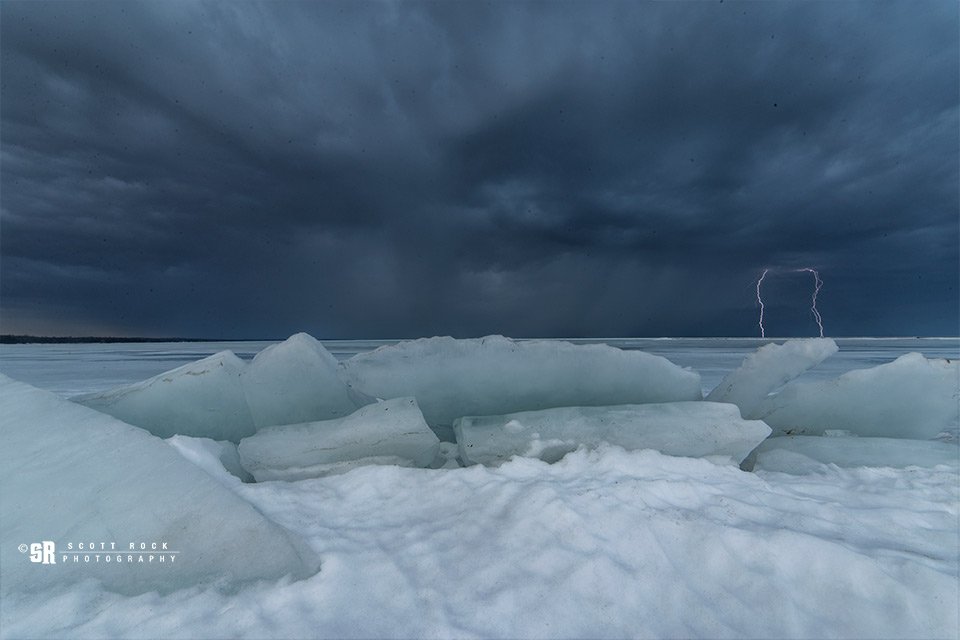Double lightning bolts captured from the frozen shoreline of Saugeen Shores, Ontario by Scott Rock @scottrockphoto