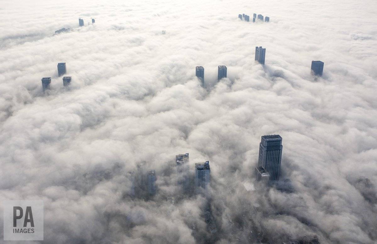 Fog swirling around the tall buildings of Yuyao City, China by Richard Holt @Richard_Holt69