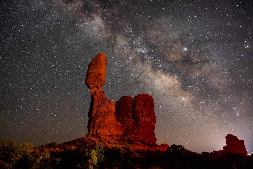 Milky Way galaxy rising over balanced rock in Arches National Park by Mike Kvackay @mkvackay