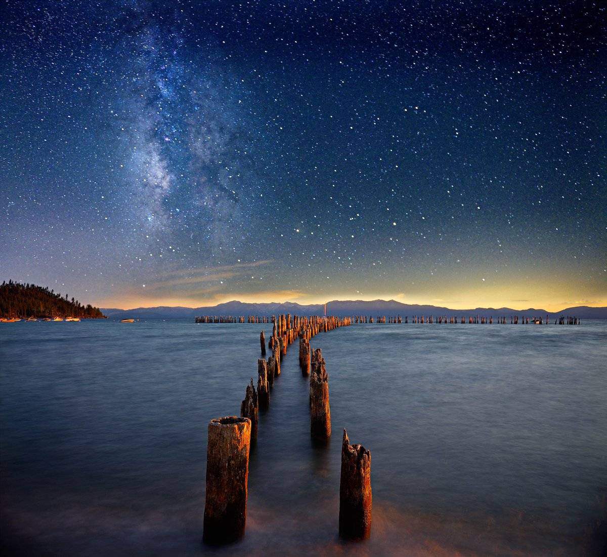 Sunset to light the old pier, and Milky Way at Lake Tahoe by David Shield @DShieldPhoto