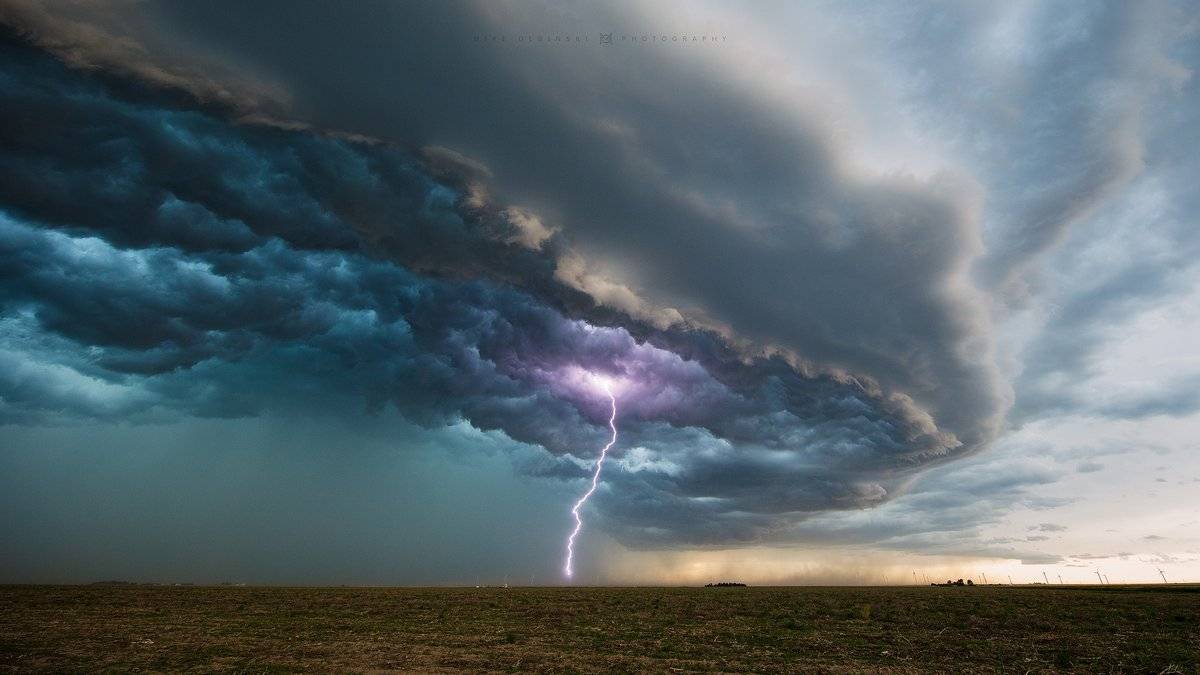 This bolt that hit a wind turbine in the distance near Sublette, KS by Mike Olbinski @MikeOlbinski