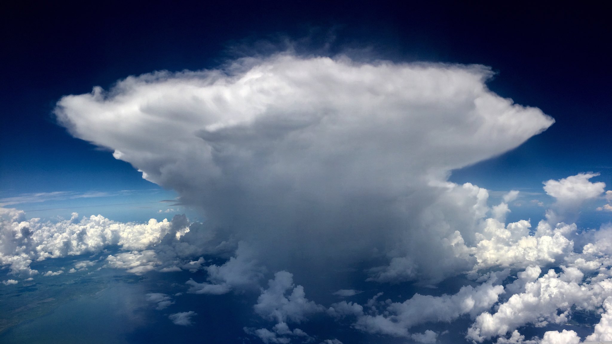 Bolts of lightning and baby thunderheads growing in the distance over South Florida by Miranda Wooster @anbaricbear