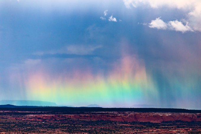A vibrant hailbow emerges behind a departing storm near Nazlini, AZ by John Sirlin @SirlinJohn