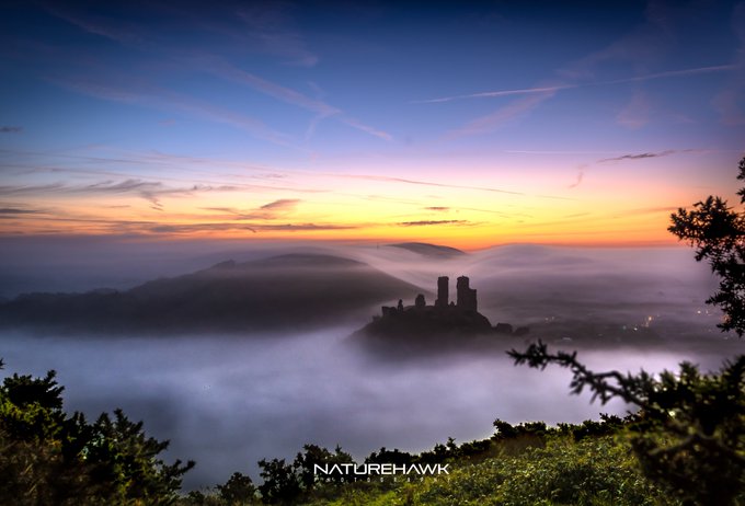 Corfe Castle bathing in the misty radiance of a Dorset sunrise by Naturehawk Photo @NaturehawkPhoto