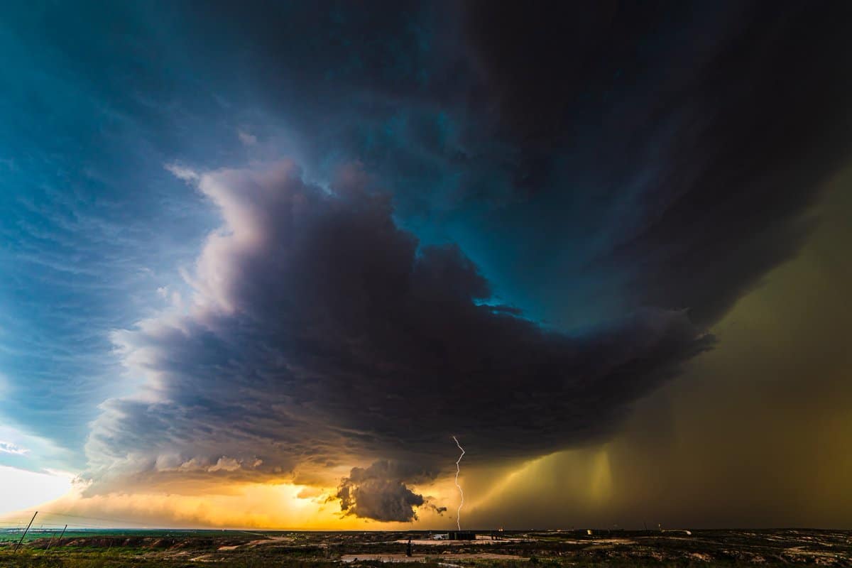1st Place An ominous looking supercell drops a bolt of lightning by Lori Grace Bailey @lorigraceaz