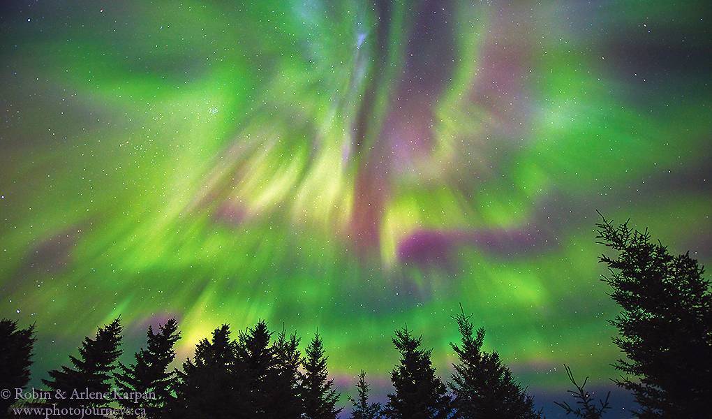 2nd Place Fire in the sky. Northern lights over the Thickwood Hills, Saskatchewan, Canada by Robin&Arlene Karpan @KarpanParkland
