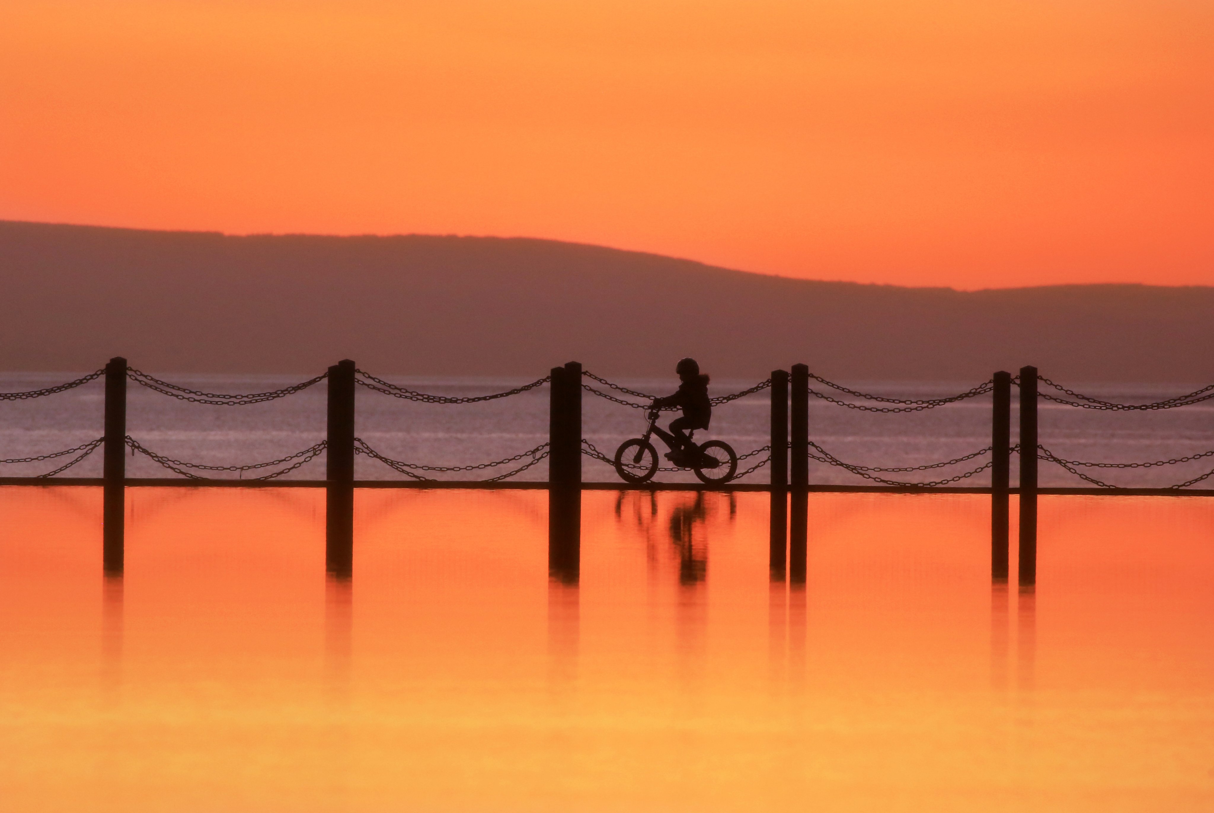 Tangerine Sunset. Cycling on the water Marine Causeway Weston-Super-Mare by Paul Silvers @Cloud9weather1
