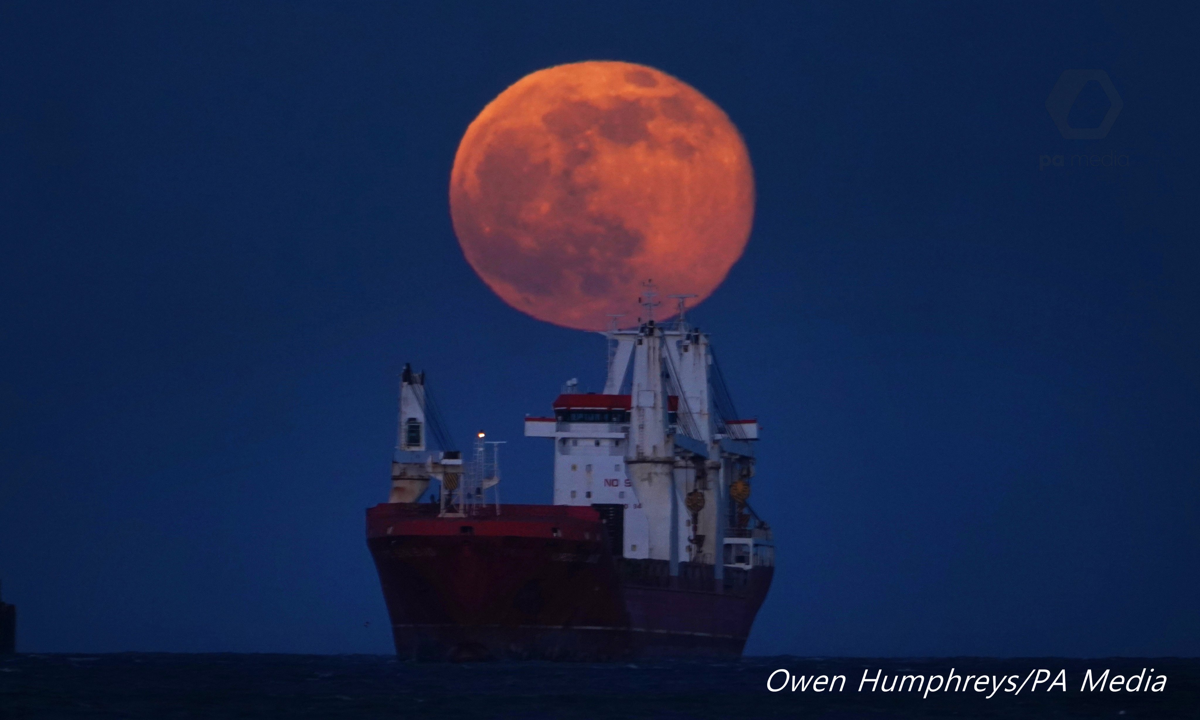 Snow Moon as it rises over a Cargo ship on the North Sea off the coast of Tynemouth UK by Owen Humphreys @owenhumphreys1