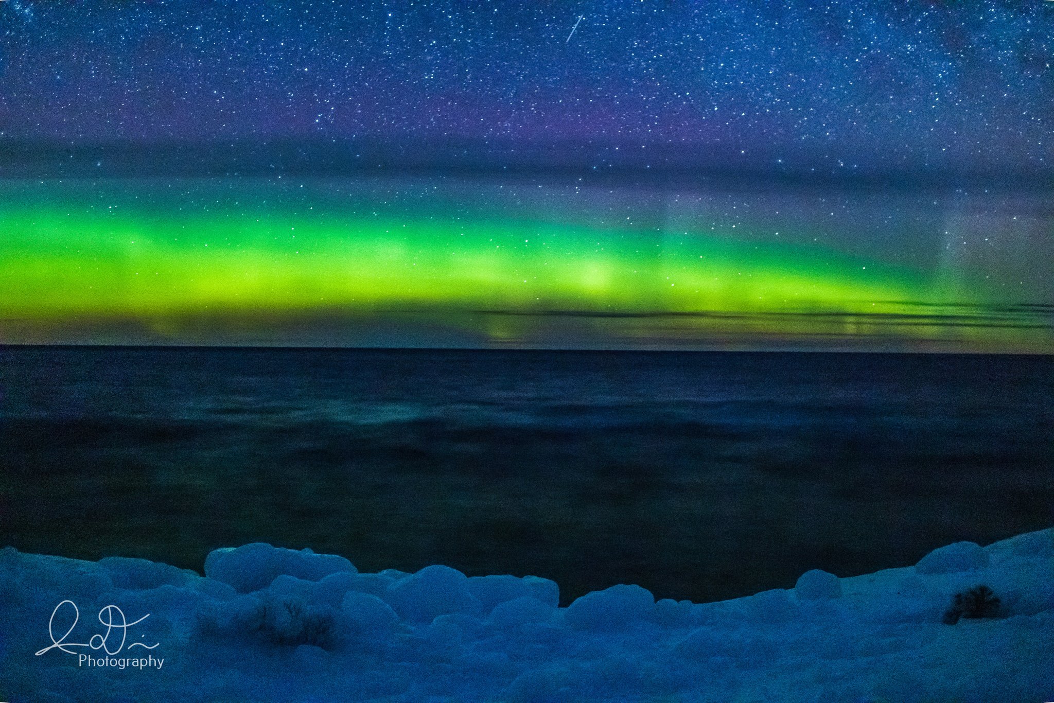 The glow of the Northern Lights light up Lake Superior by isaac @ID_Photo_Graphy