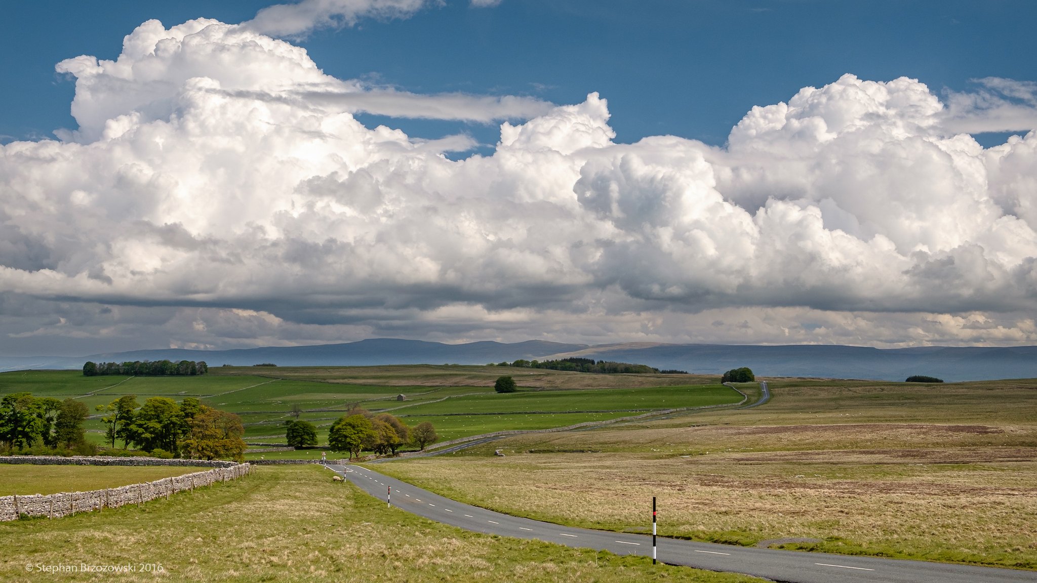 1st Place Cumulus clouds dwarfing the highest fells of the North Pennines, seen from Orton Scar in Cumbria by Stephan Brzozowski @stephanbrz