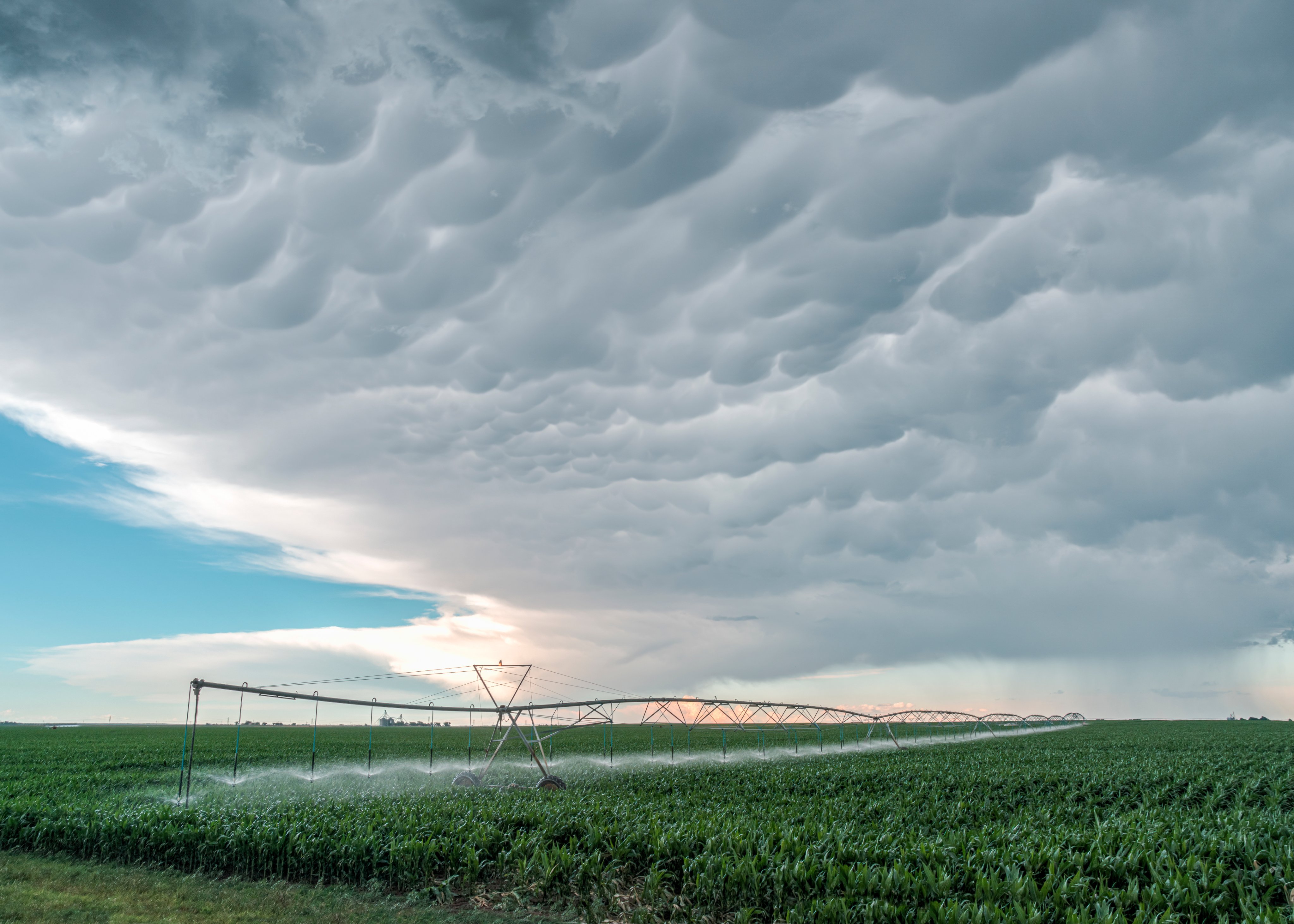 3rd Place Irrigating a KS farm field with mammatus overhead by Laura Hedien- Storm Clouds Photography @lhedien
