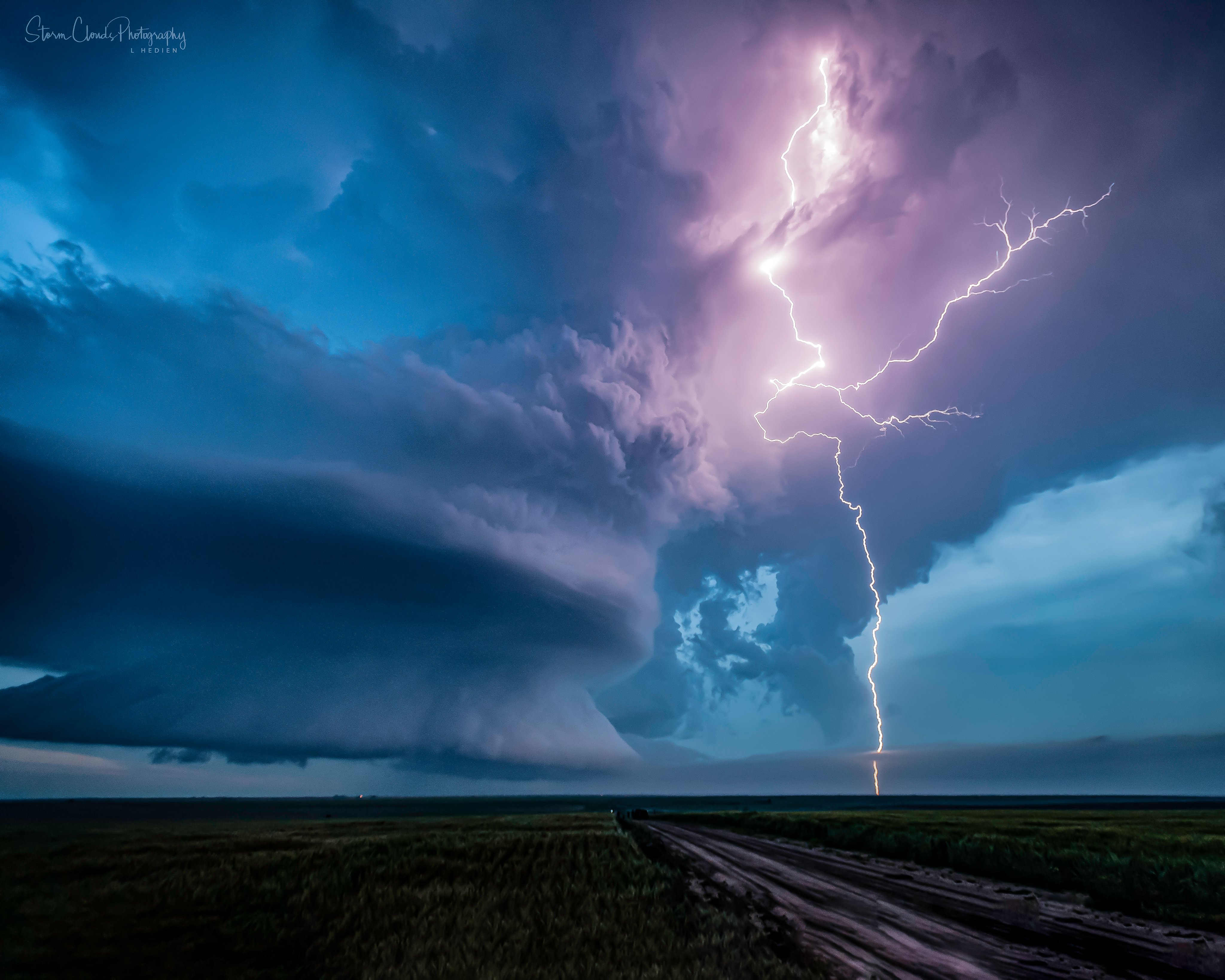 2nd Place Selden, Kansas supercell droppping lightning during a June storm by Laura Hedien- Storm Clouds Photography @lhedien