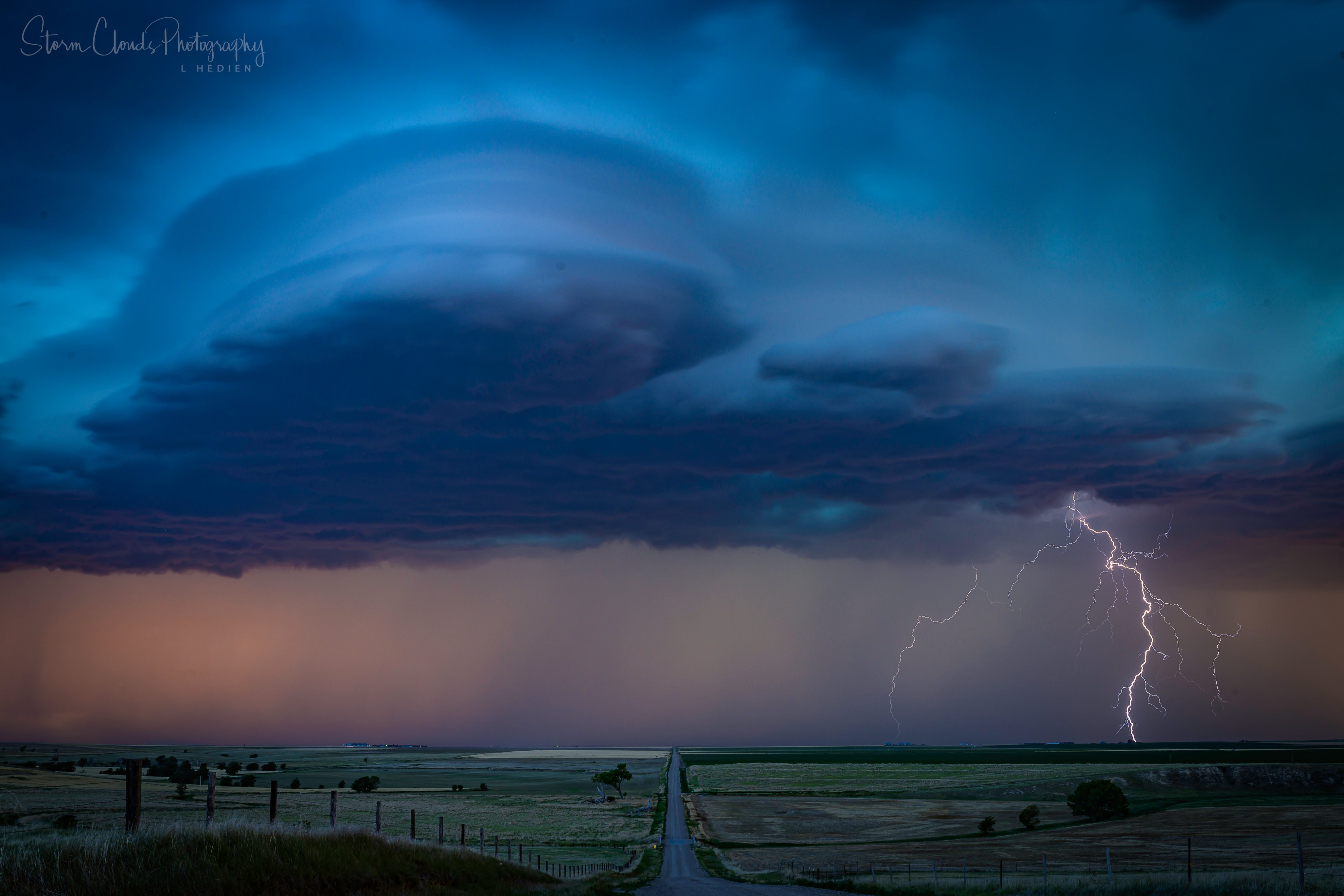 2nd Place Supercell and lightning bolts in a valley near Brewster Kansas by Laura Hedien @lhedien