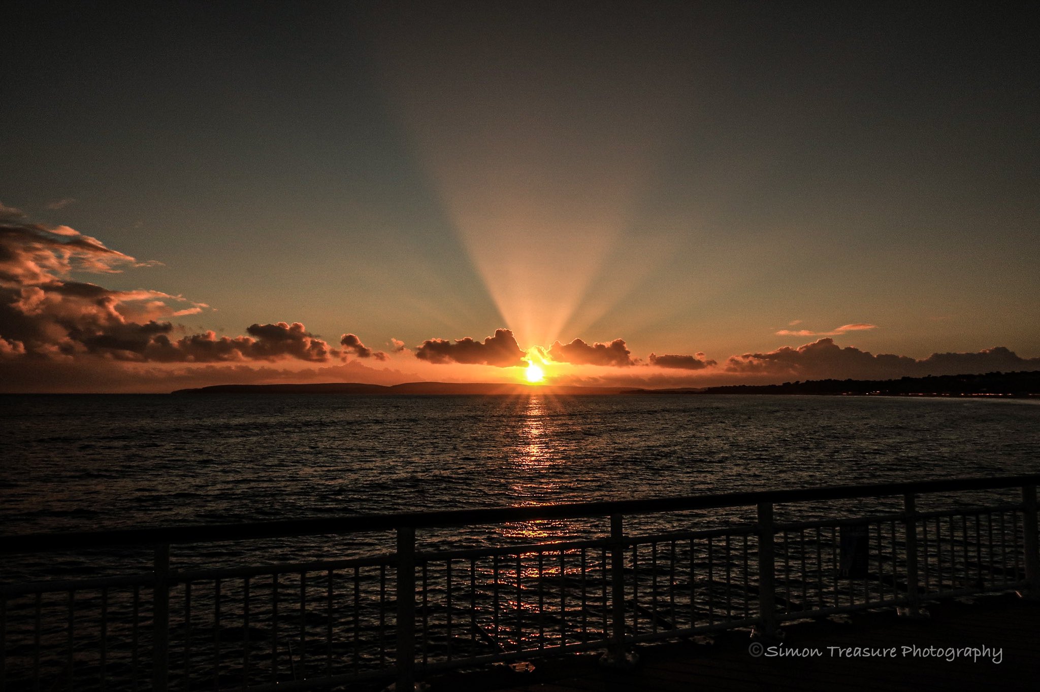 3rd Place Sun setting with Crepuscular rays over Purbeck hills & Poole Bay Bournemouth by Simon Treasure @Simon_Treasure